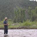 standing in a riffle with a hooked trout