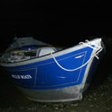 drift boat on shorline at first light